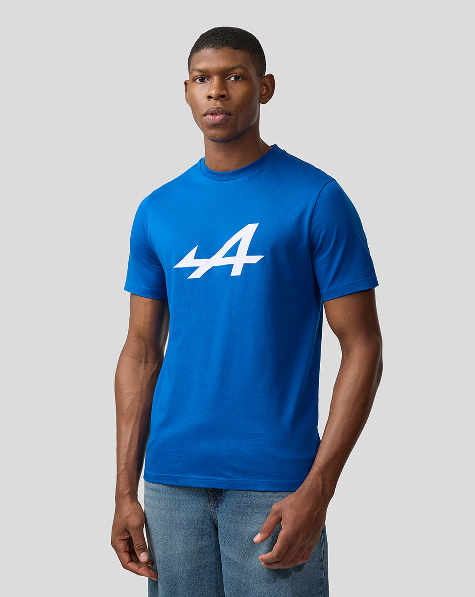Male model in lapis blue Alpine Core Essentials T-Shirt with large white logo on the chest.