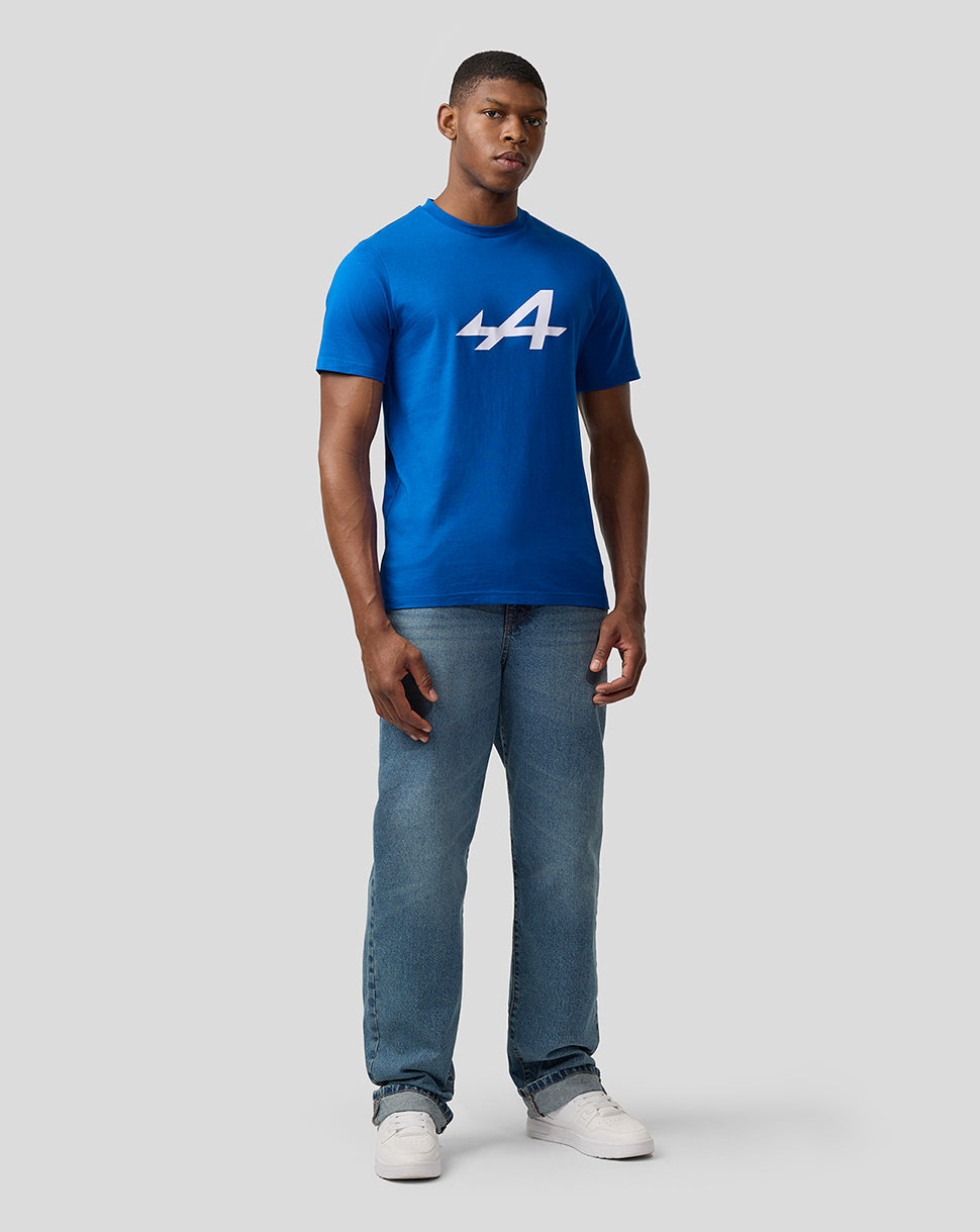Front view of a man in a lapis blue Alpine Core Essentials T-shirt with a bold white logo on the chest.