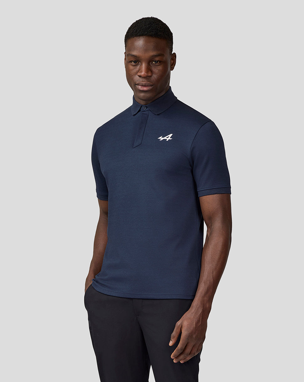 Male model in navy Alpine Core Essentials Polo Shirt with white Alpine logo on the chest
