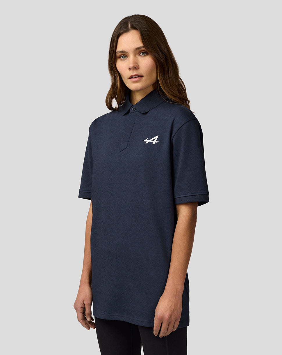 Female model in dark navy Alpine Core Essentials Polo Shirt with white Alpine logo on the chest