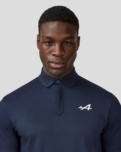 Male model wearing Alpine Core Essentials Polo Shirt in Black Iris with chest logo.