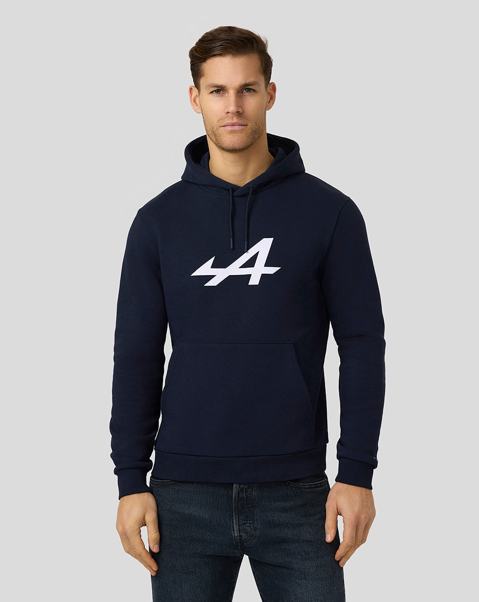 Male model wearing navy Alpine Core Essentials Hoodie with bold front print, left sleeve logo and a kangaroo pocket.