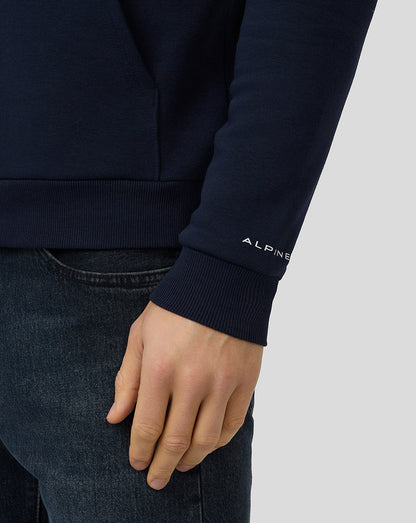 Close up of a navy Core Essentials Hoodie sleeve displaying the Alpine logo at the cuff