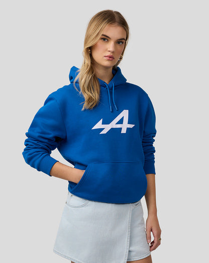 Model wearing blue Alpine Core Essentials Hoodie with front kangaroo pocket and center chest logo