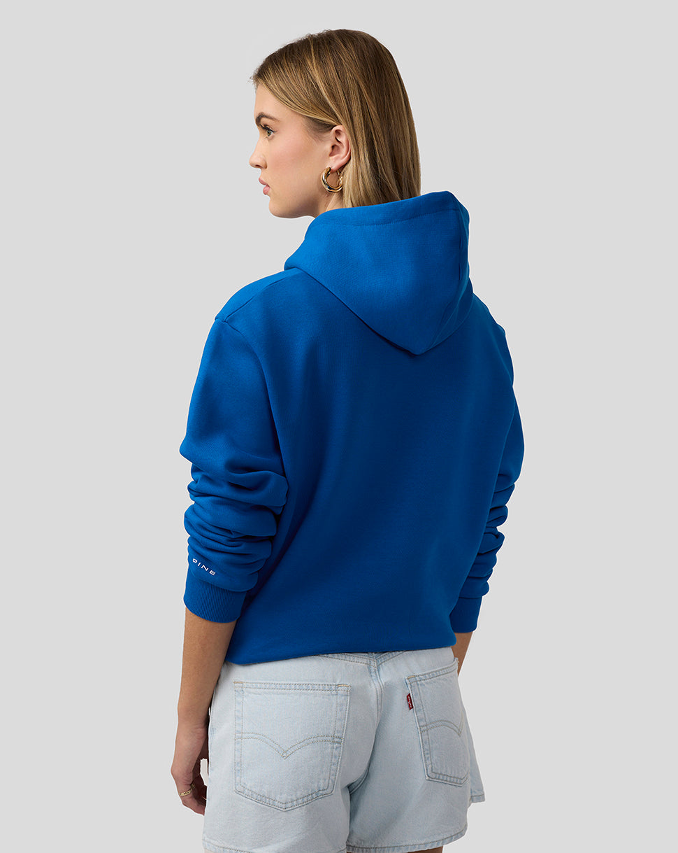 Back view of woman wearing blue Alpine Core Essentials Hoodie
