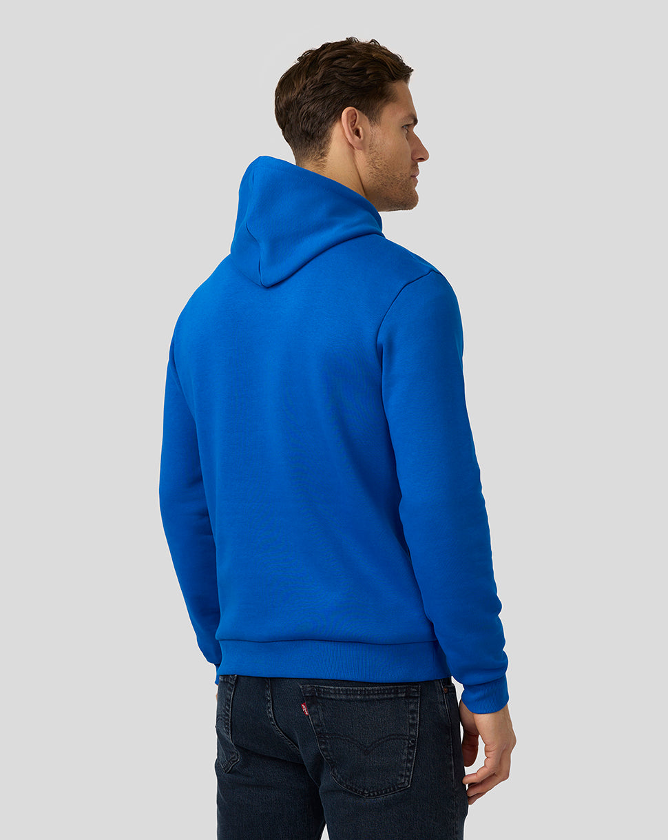 Back view of male model in blue Alpine Core Essentials Hoodie with hood resting at the back