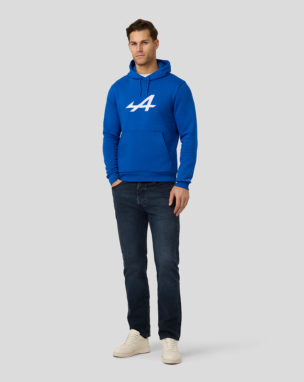 Male model wearing lapis blue Alpine Core Essentials Hoodie with large white logo on the chest and a front kangaroo pocket
