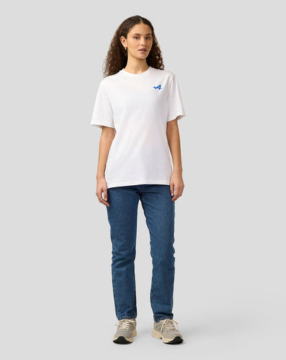 Full body view of a woman wearing a white Alpine Graphic T-Shirt with a blue logo on the chest