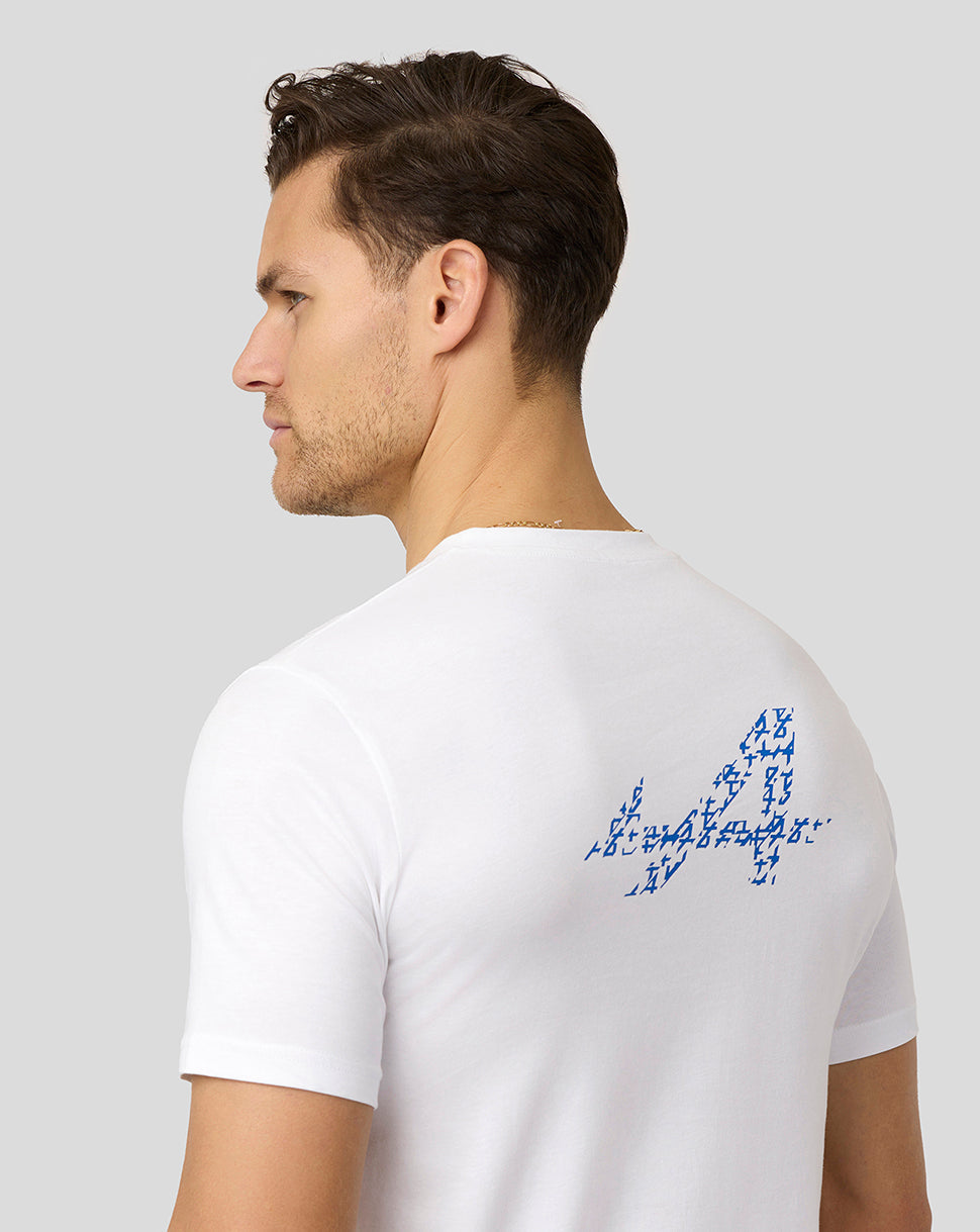 Back view of a man wearing a white Alpine T-shirt with a large blue logo on the upper back.