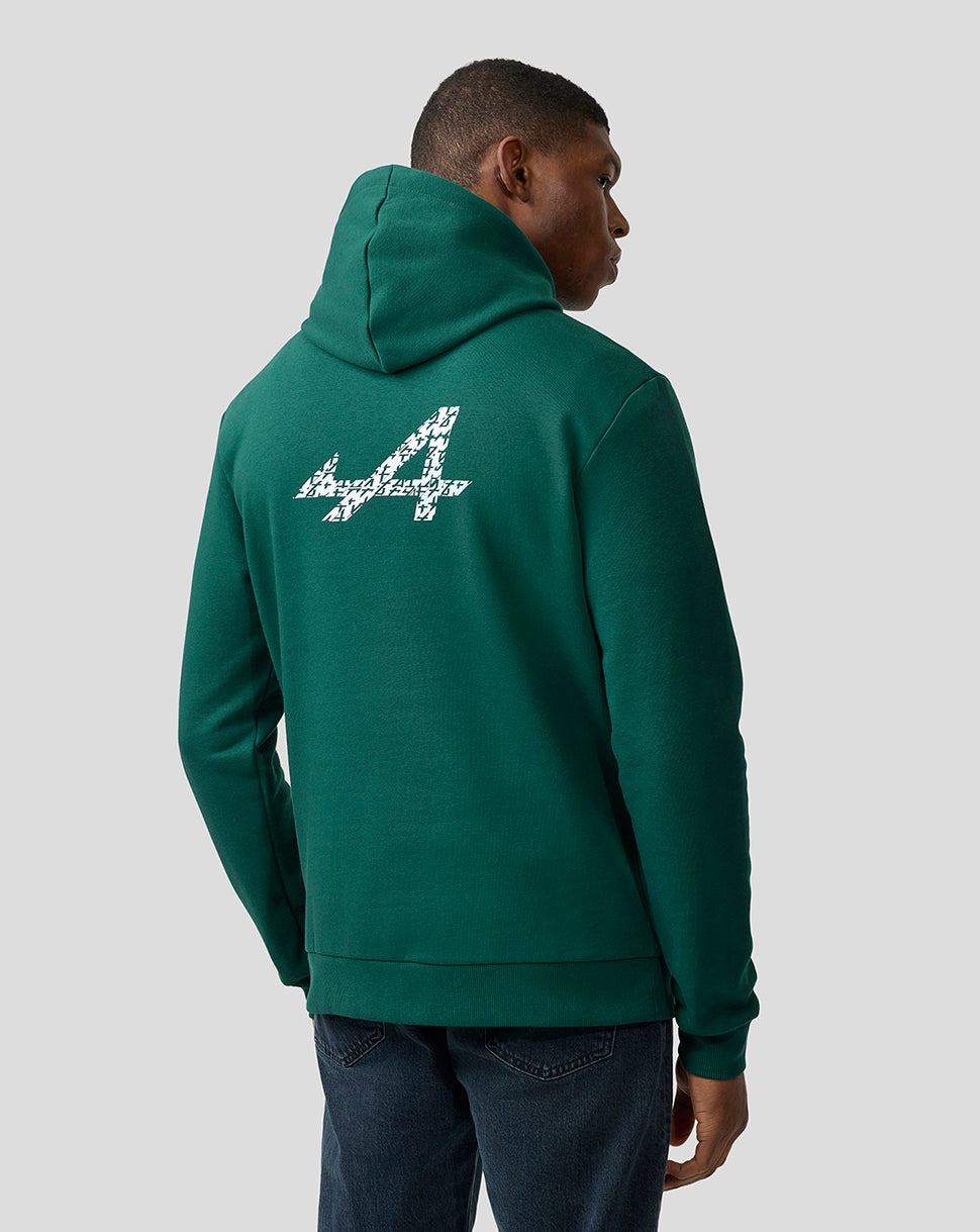 Back view of a person wearing a forest green Alpine hoodie with a large patterned white logo on the back