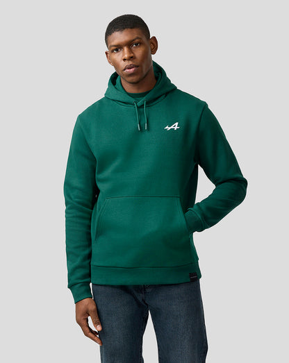 Close up of male model in botanical green Alpine hoodie with white logo on chest.