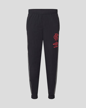 Front view of junior dark travel pants with elastic waistband white piping along the legs and red Rangers crest with Umbro logo.