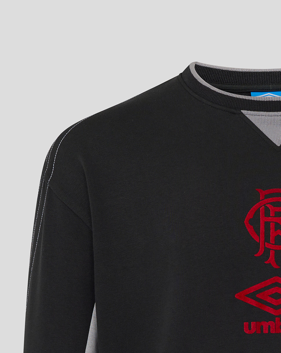 Close up of a black Rangers travel crew sweatshirt with white topstitching on the sleeve and a red club crest.