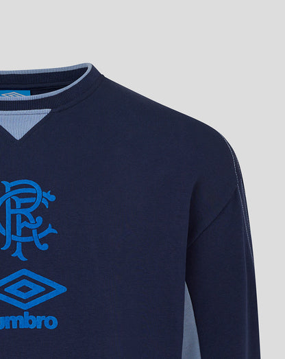 Close up of navy Rangers travel crew sweat showing club crest and Umbro logo on chest