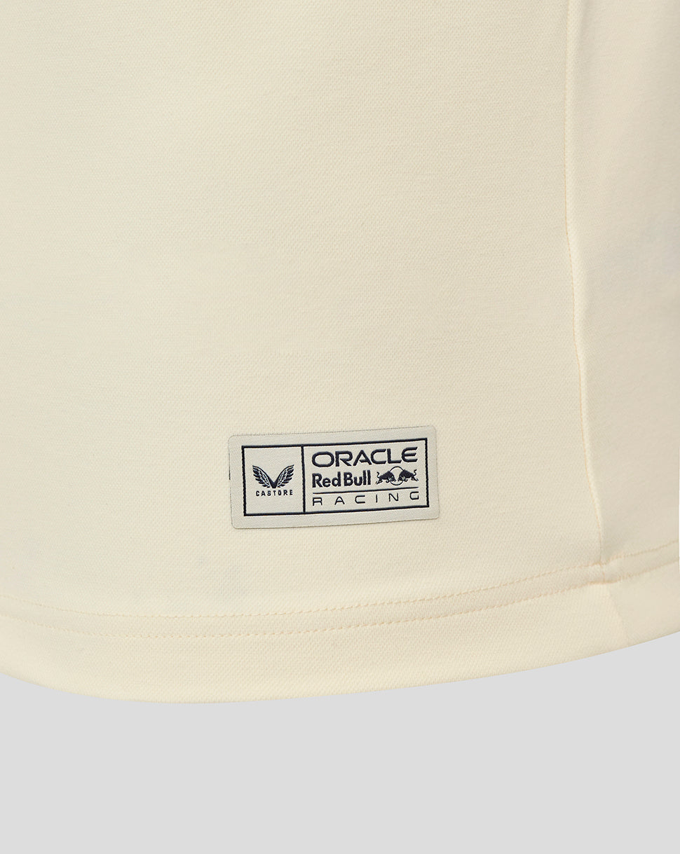 Close up of the cream heritage polo hem with a small Oracle Red Bull Racing badge.