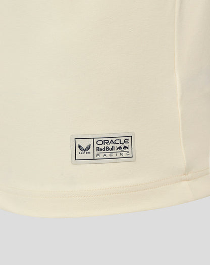 Close up of the cream heritage polo hem with a small Oracle Red Bull Racing badge.