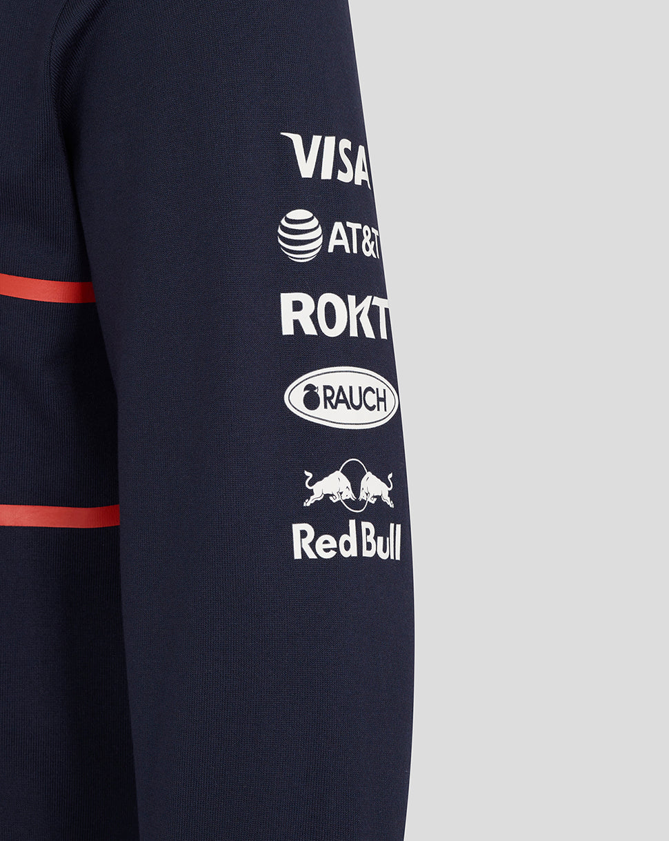 Navy heritage polo sleeve with red stripe and sponsor logos including Visa AT&T Rakuten Rauch and Red Bull