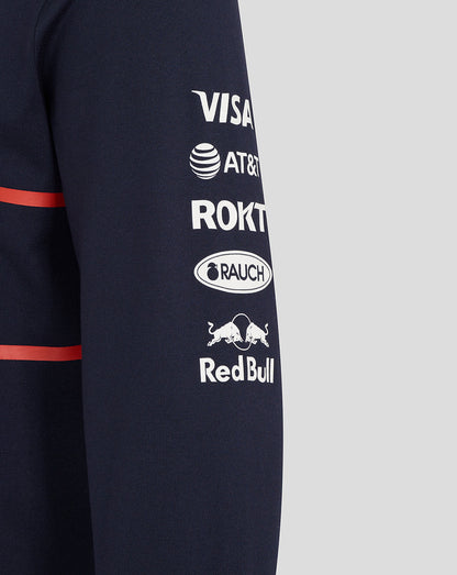 Navy heritage polo sleeve with red stripe and sponsor logos including Visa AT&T Rakuten Rauch and Red Bull