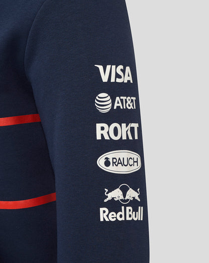 Navy hoodie sleeve with white sponsor logos including Visa AT&T ROKT Rauch and Red Bull.