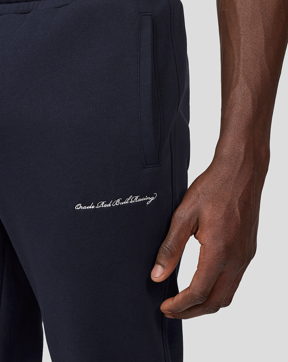 Close-up of navy joggers showing a zip side pocket and white Oracle Red Bull Racing script on the thigh.