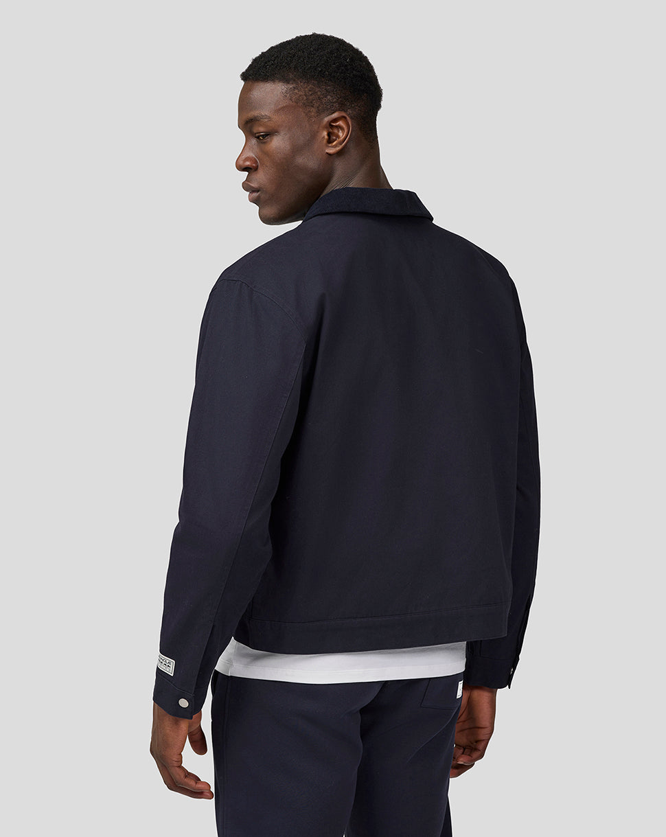 Back view of a male model in navy night sky script work jacket, highlighting the collar and clean silhouette.