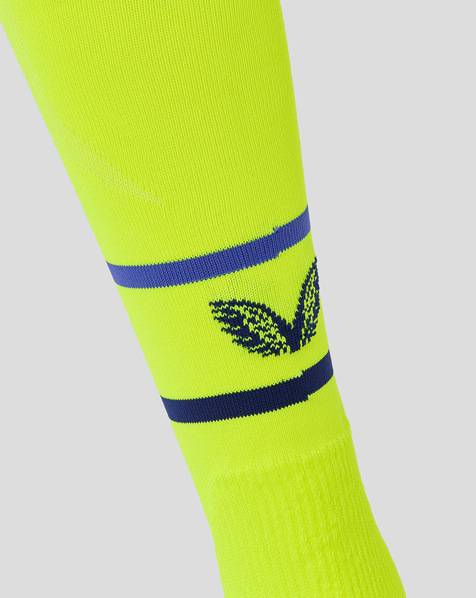 Neon yellow junior sock with two navy stripes and a navy leaf logo