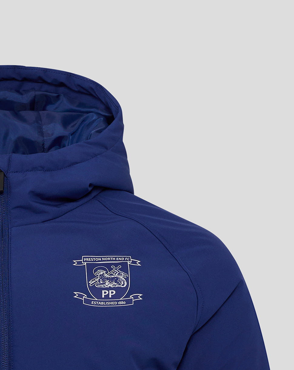 Shoulder close up on the blue Preston North End training jacket displaying the club crest.