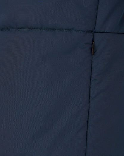 Close up of navy padded training jacket fabric with horizontal stitching and a black zipper pull