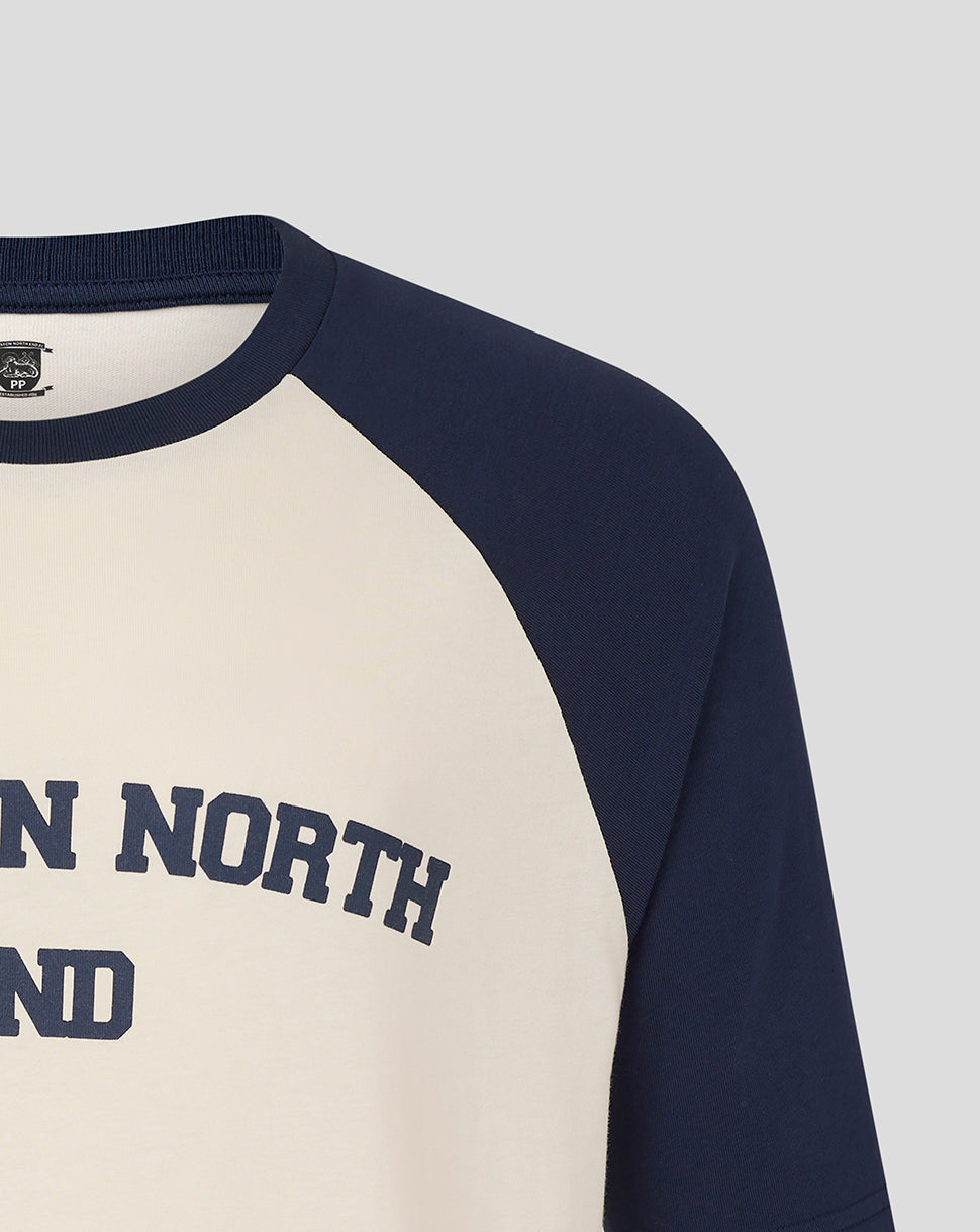 Chest close up displaying Preston North End graphic on cream raglan tee with navy sleeves