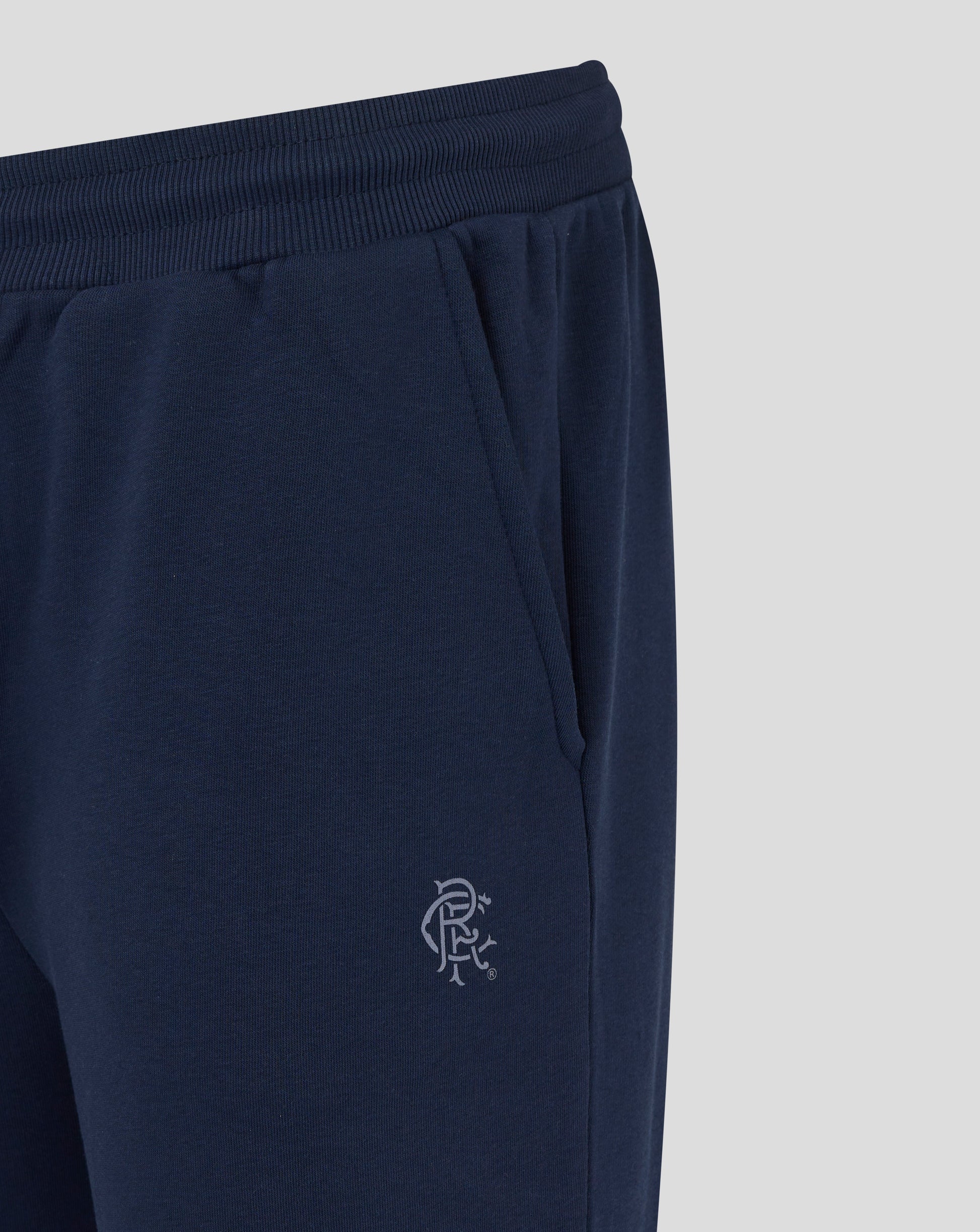 Close up of navy Rangers joggers waistband with ribbed elastic and a partial Rangers crest visible near the thigh
