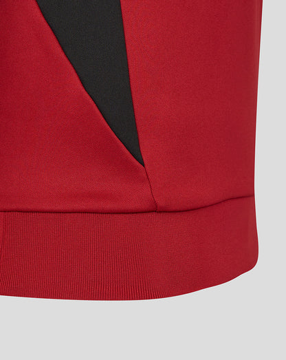 Hem detail of red Saracens training sweatshirt with black panel accent.