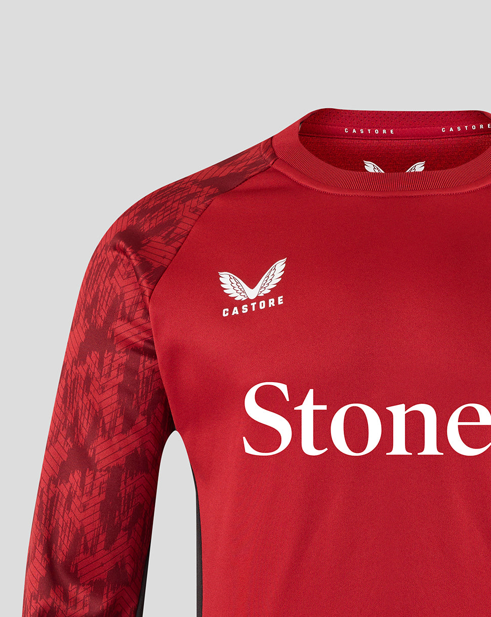 Close-up of red Saracens training sweatshirt with StoneX sponsor text and crest on the chest.