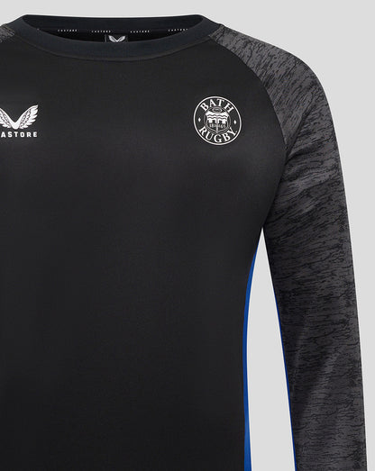 Close up of Bath Rugby sweatshirt chest area showing Castore logo on left and Bath Rugby crest on right.