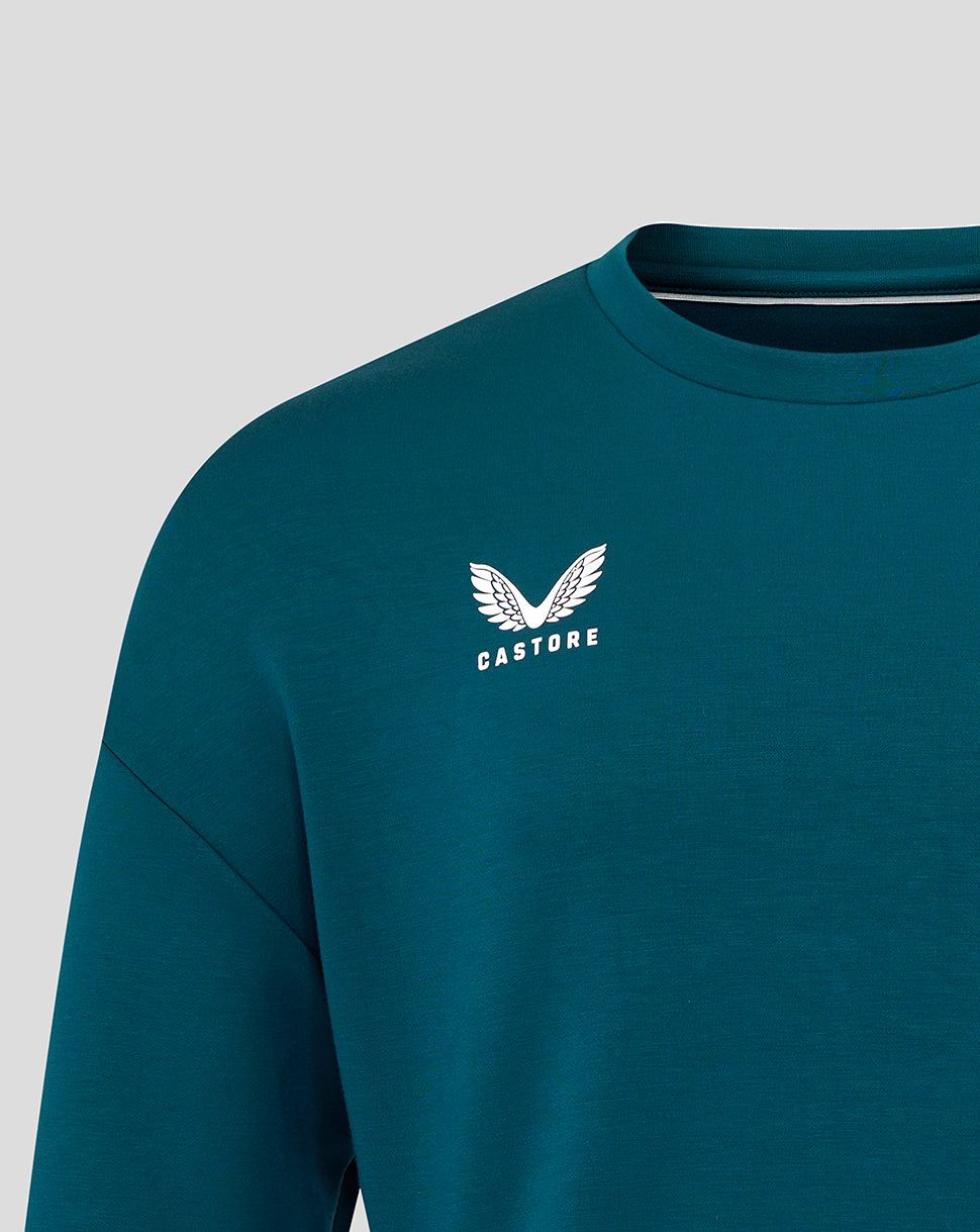 Close up of Castore logo on chest of teal Reflecting Pond Travel Crew Sweatshirt
