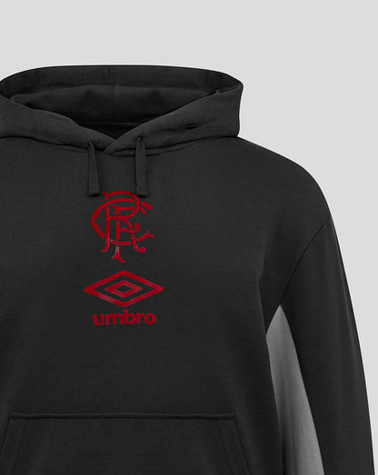 Close up of chest area on black Rangers travel hoodie showing red club crest and Umbro logo.