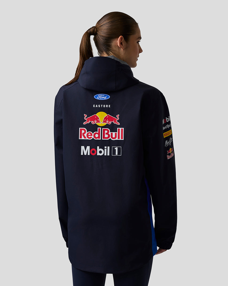 Back view of model in navy Red Bull Teamline jacket with large Red Bull logo across the back.