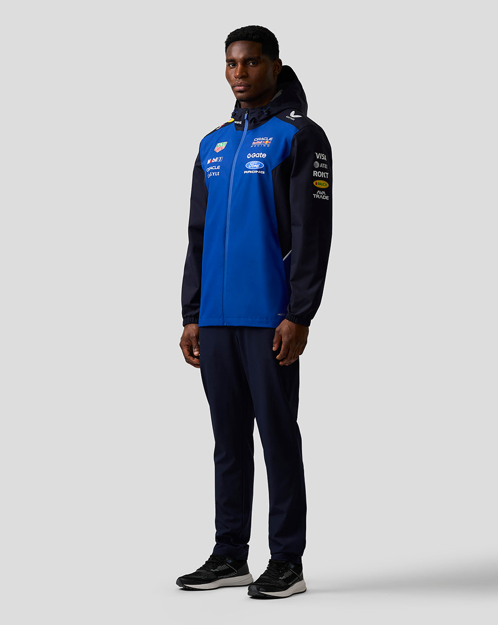Male model wearing Oracle Red Bull Racing Teamline water resistant jacket in Night Sky with hood and sponsor logos.