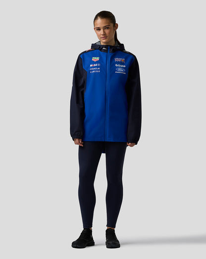 Female model wearing Oracle Red Bull Racing Teamline water resistant jacket in Night Sky with hood and sponsor logos.