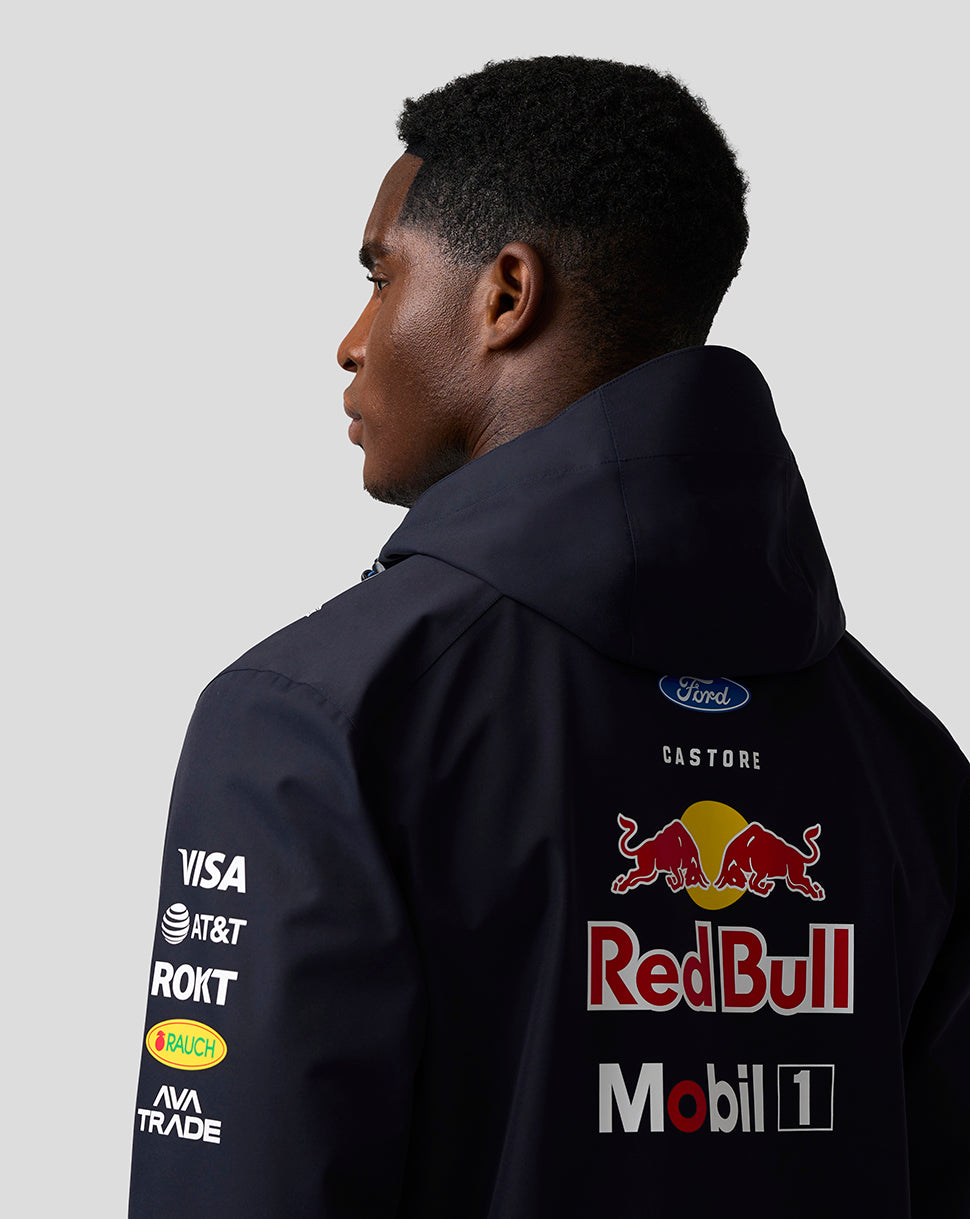 Model wearing navy Oracle Red Bull Racing Teamline jacket with large Red Bull logo on back