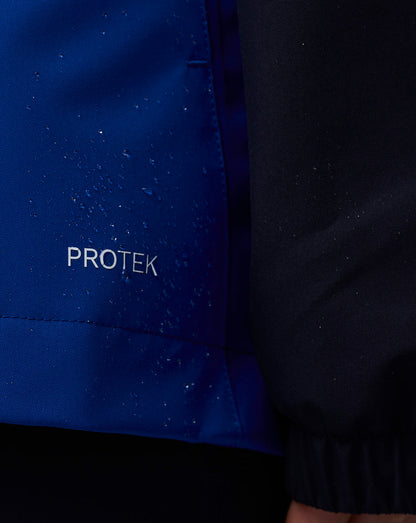 Close up of blue ProTek jacket fabric with water droplets and PROTEK lettering