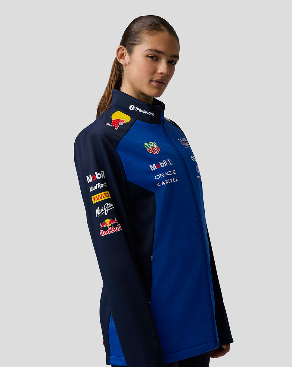 Female model wearing navy night sky Oracle Red Bull Racing Teamline Soft Shell Jacket with chest logos.