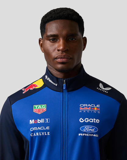 Male model wearing Oracle Red Bull Racing Teamline Soft Shell Jacket in night sky blue with navy shoulders and chest logos