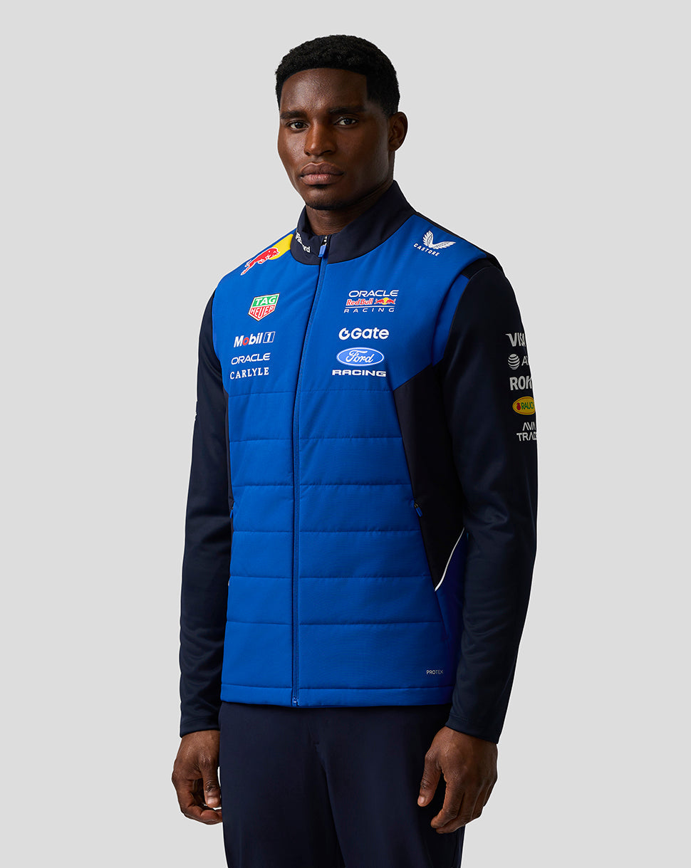 Front view of a man wearing a blue Oracle Red Bull Racing Teamline Gilet with sponsor logos.