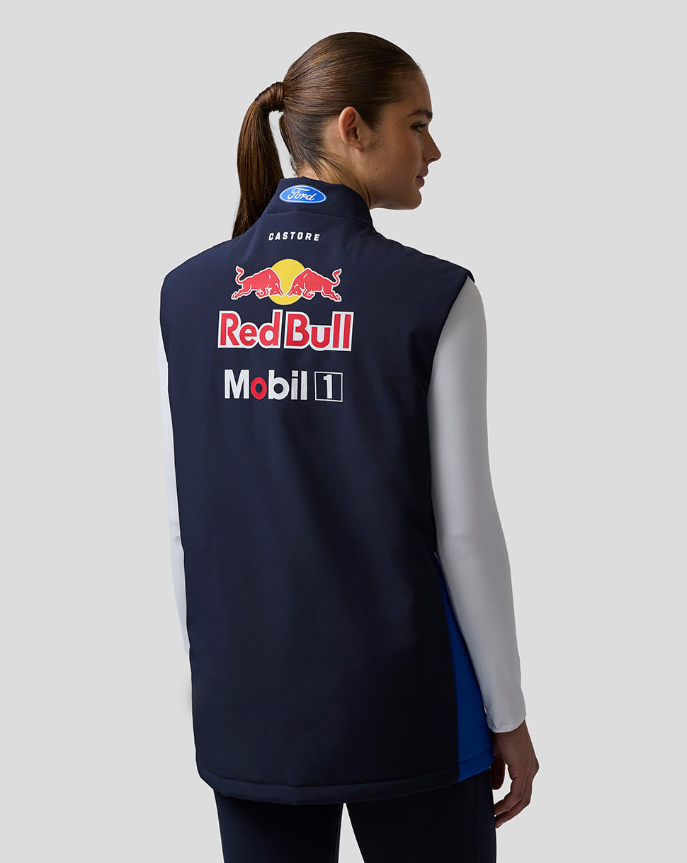 Back view of a model wearing a navy Oracle Red Bull Racing Teamline Gilet with a large Red Bull logo on the back.