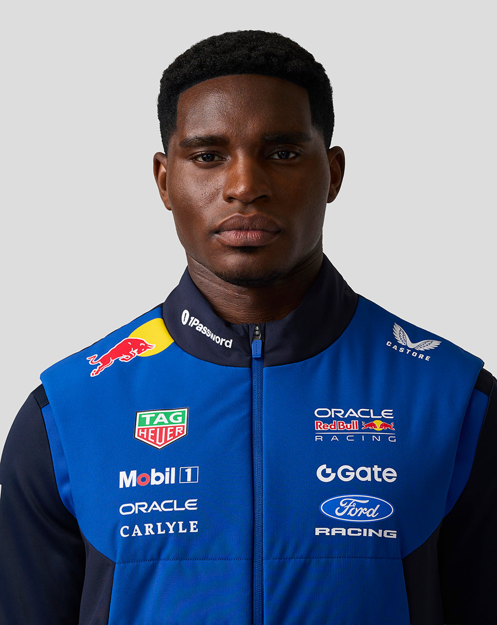 Male model wearing blue Oracle Red Bull Racing Teamline Gilet with sponsor logos on the chest.