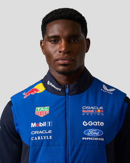 Male model wearing blue Oracle Red Bull Racing Teamline Gilet with sponsor logos on the chest.
