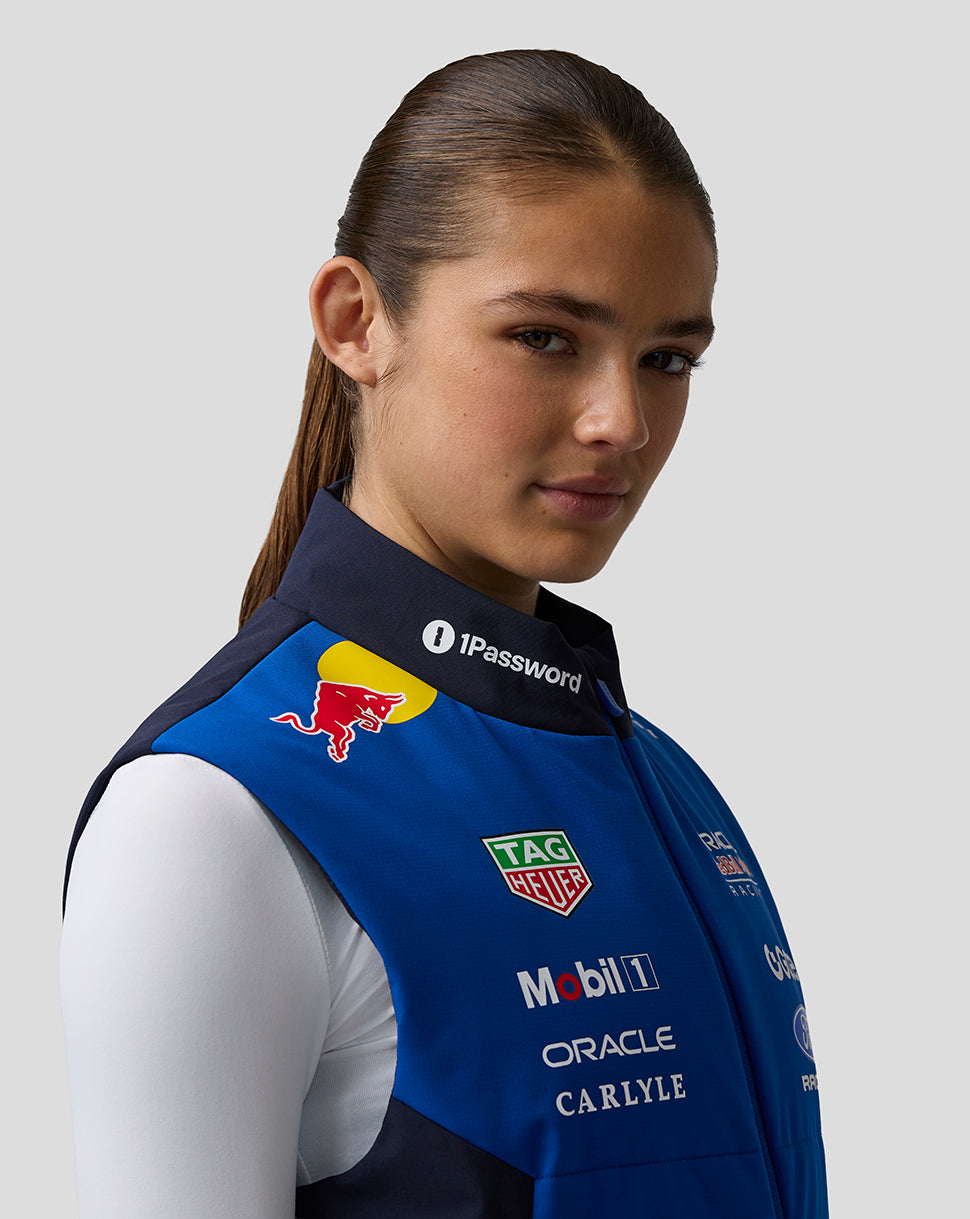 Female model wearing blue Oracle Red Bull Racing Teamline Gilet with front sponsor logos.
