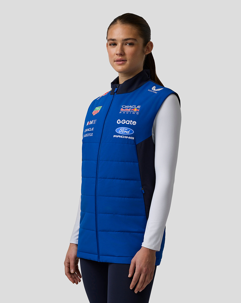 Model wearing blue Oracle Red Bull Racing Teamline Gilet over a white long sleeve top.