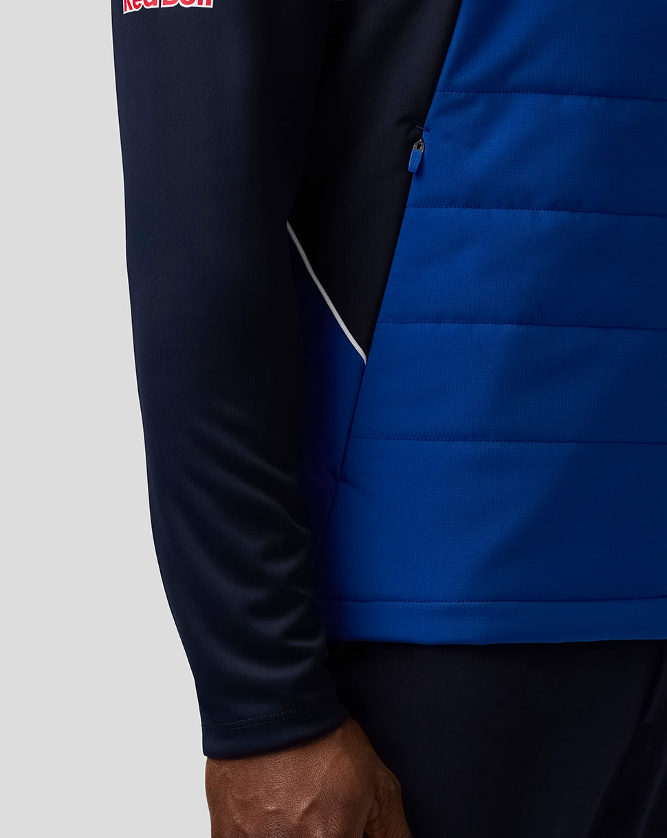 Close up of blue Teamline Gilet side zipper with quilted panels.
