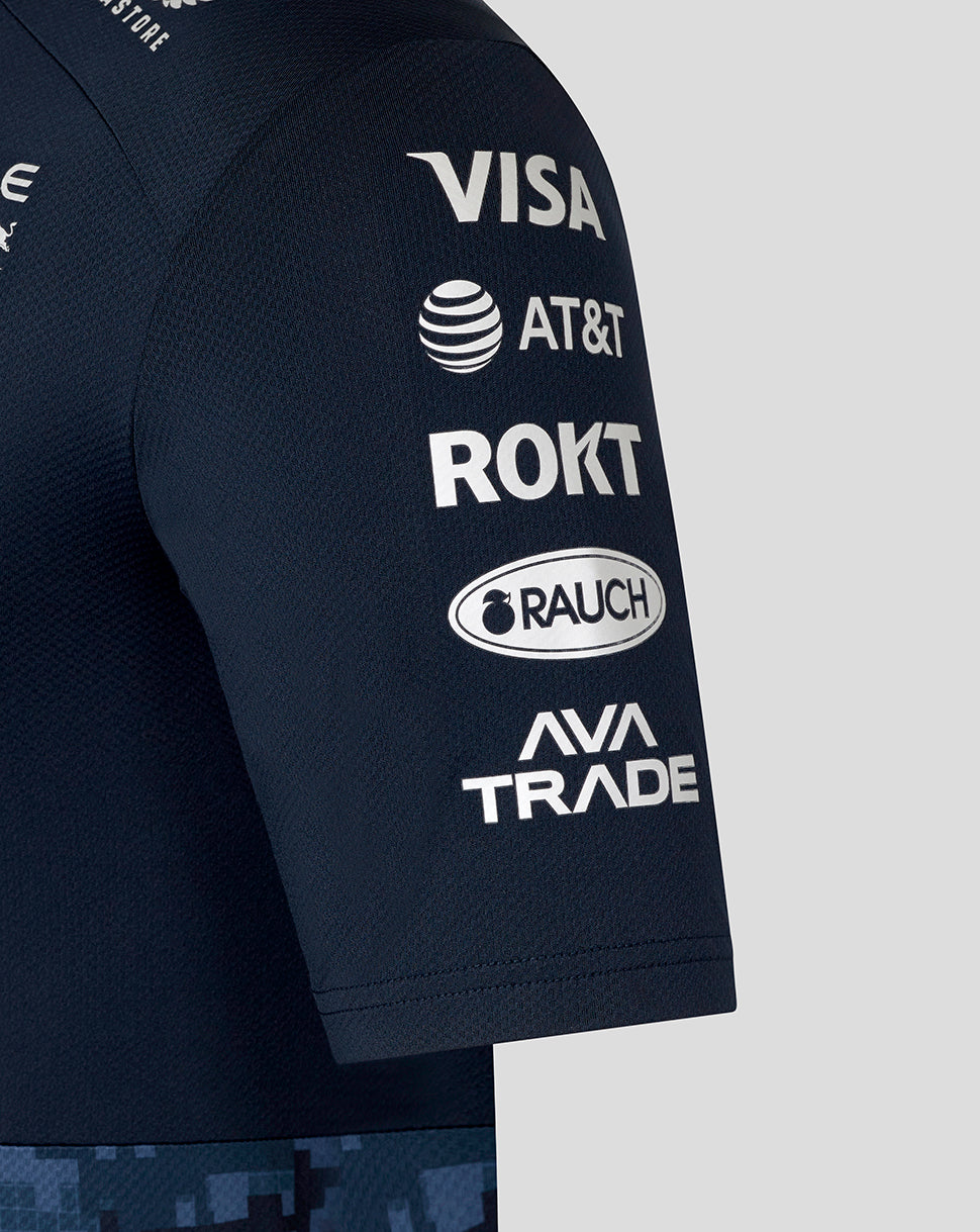 Sleeve close up of the navy track polo displaying sponsor logos including Visa AT&T ROKT Rauch and AVA Trade.